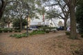 A gorgeous spring landscape at Franklin Square with lush green weeping willow trees and plants along a footpath