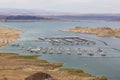 a gorgeous spring landscape at Lake Mead with vast blue water and majestic mountain ranges and boats and yachts docked Royalty Free Stock Photo