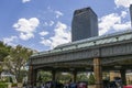 A gorgeous spring landscape with parked cars and people and hotels in the city skyline, a gorgeous blue sky with clouds