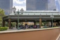 A gorgeous spring landscape with parked cars and people and hotels in the city skyline, a gorgeous blue sky with clouds