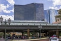 A gorgeous spring landscape with parked cars and people and hotels in the city skyline, a gorgeous blue sky with clouds