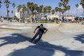a gorgeous spring landscape at Venice Beach Skatepark at Venice Beach with young men riding skateboards and people watching Royalty Free Stock Photo