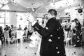 gorgeous stylish happy bride and groom performing their emotional first dance, wedding in a restaurant