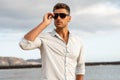 Gorgeous stylish man wearing fashionable shirt and sunglasses. City style Royalty Free Stock Photo