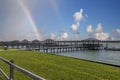 a gorgeous summer landscape along Banks Channel with brown wooden boat docks and boats with rippling water, lush green grass Royalty Free Stock Photo