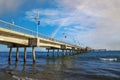 A gorgeous summer landscape at the Belmont Veterans Memorial Pier with blue ocean water and waves rolling into the beach Royalty Free Stock Photo