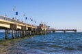 A gorgeous summer landscape at the Belmont Veterans Memorial Pier with blue ocean water and waves rolling into the beach Royalty Free Stock Photo