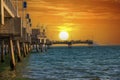 A gorgeous summer landscape at the Belmont Veterans Memorial Pier with blue ocean water and waves rolling into the beach Royalty Free Stock Photo