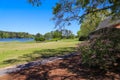 A gorgeous summer landscape in the garden with a blue lake, lush green trees, grass and plants and colorful flowers Royalty Free Stock Photo