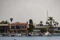 a gorgeous summer landscape at Horny Corner Beach with luxury homes and boats and yachts docked along the banks