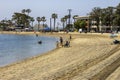 a gorgeous summer landscape at Horny Corner Beach with people relaxing in the sand, bikes parked on the sand, apartments