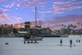 a gorgeous summer landscape at Horny Corner Beach with people sailing boats and people rowing paddle boards with yachts Royalty Free Stock Photo