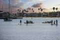 a gorgeous summer landscape at Horny Corner Beach with people sailing boats and people rowing paddle boards with yachts Royalty Free Stock Photo