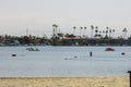 a gorgeous summer landscape at Horny Corner Beach with people sailing boats and people rowing paddle boards with yachts Royalty Free Stock Photo