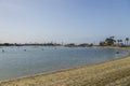 a gorgeous summer landscape at Horny Corner Beach with people sailing boats and people rowing paddle boards with yachts Royalty Free Stock Photo