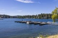 A gorgeous summer landscape at Lake Arrowhead with a family standing on the back of a boat surrounded by blue water
