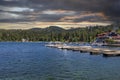 A gorgeous summer landscape at Lake Arrowhead village with boats and yachts sailing on the rippling blue later water, homes