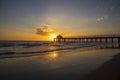 A gorgeous summer landscape at the Manhattan Beach Pier with a stunning sunset in the sky with blue ocean water and waves Royalty Free Stock Photo