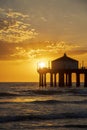 A gorgeous summer landscape at the Manhattan Beach Pier with a stunning sunset in the sky with blue ocean water and waves Royalty Free Stock Photo