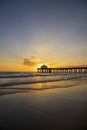 A gorgeous summer landscape at the Manhattan Beach Pier with a stunning sunset in the sky with blue ocean water and waves Royalty Free Stock Photo