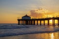 A gorgeous summer landscape at the Manhattan Beach Pier with a stunning sunset in the sky with blue ocean water and waves Royalty Free Stock Photo