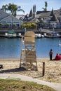 A gorgeous summer landscape at Seabridge Park with a family relaxing in the sand on the beach with boats and yachts in the harbor