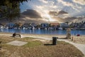 A gorgeous summer landscape at Seabridge Park with a family relaxing in the sand on the beach with boats and yachts in the harbor