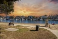 A gorgeous summer landscape at Seabridge Park with a family relaxing in the sand on the beach with boats and yachts in the harbor