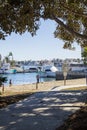 A gorgeous summer landscape at Seabridge Park with a young children playing in the sand on the beach with boats and yachts