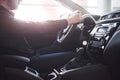 Gorgeous sunlight. Close up side view of man sitting in the modern car with black interior Royalty Free Stock Photo