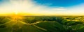 Gorgeous sunset over beautiful green vineyards. Aerial panorama sunset over Austrian grape hills in spring