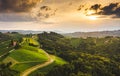 Gorgeous sunset over beautiful green vineyards. Aerial shoot of grape hills in summer