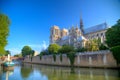 Gorgeous sunset over Notre Dame cathedral with puffy clouds, Par Royalty Free Stock Photo