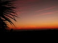 Gorgeous sunset on a White sandy beach under a cloudy sky with white fluffy clouds Royalty Free Stock Photo