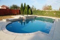 Gorgeous swimming pool in lush back yard Royalty Free Stock Photo