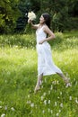 Gorgeous teenage girl jumping in a flowery meadow Royalty Free Stock Photo