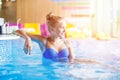 Gorgeous teenage girl sitting in pool near the bar Royalty Free Stock Photo