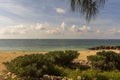 Gorgeous tropical landscape view. Cute green plants, sand coast line on dark blue Atlantic ocean water.