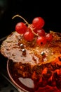 gorgeous view of burnt caramel crust with red currant on glass of drink Royalty Free Stock Photo