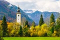 Gorgeous view of colorful autumnal scene of famous Church of St John the Baptist at Bohinj Lake