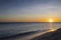 Gorgeous view of orange sunset on sandy beach of Eagle Beach in Atlantic Ocean on Aruba island.. Royalty Free Stock Photo