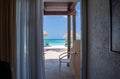 Gorgeous view on sandy beach and Atlantic Ocean from a room. Sun beds and umbrellas on turquoise water and blue sky background. Royalty Free Stock Photo