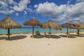 Gorgeous view of sandy Eagle beach turquoise water of Atlantic ocean with sun parasols. Royalty Free Stock Photo