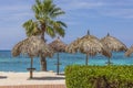 Gorgeous view of sun umbrellas on turquoise water surface merging with blue sky on horizon. Royalty Free Stock Photo