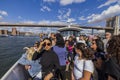 Gorgeous view of tourists on excursion boat near Brooklyn Bridge, New York, USA.