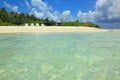 Gorgeous view of white sand bikini beach, Maldives. Clear turquoise water of Indian Ocean, green trees and blue sky Royalty Free Stock Photo