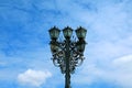 Gorgeous vintage style wrought iron streetlamp against blue sky