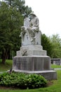 Old weathered statue marking family plot in historic cemetery, Saratoga Springs, New York, 2018,