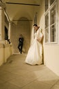 Gorgeous wedding couple bride and groom posing on historical balcony and having fun