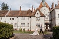 Gorgeous wedding couple hugging and walking near old castle in sunny beautiful park. Stylish beautiful bride and groom posing on Royalty Free Stock Photo